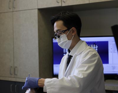 Dr. Harry Shin providing dental care for a patient at Moritis & Shin Dentistry