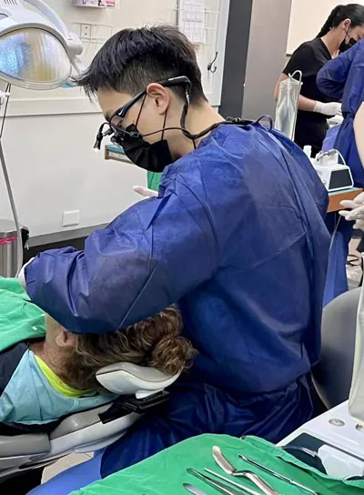 Dr. Harry Shin providing dental care to a patient