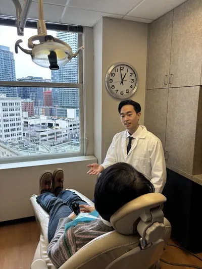 Dr. Shin discussing dental care with a patient