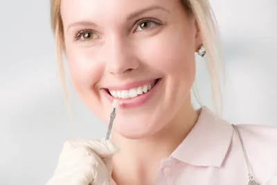 woman selecting which color dental veneer she would like
