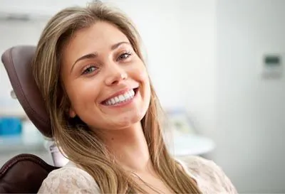 woman showing off her newly restored smile thanks to dental crowns from Moritis & Shin Dentistry in Seattle, WA