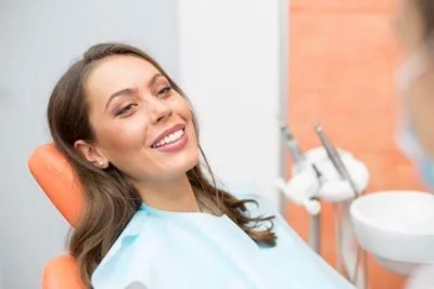 woman smiling in the dental chair during her visit to Moritis & Shin Dentistry