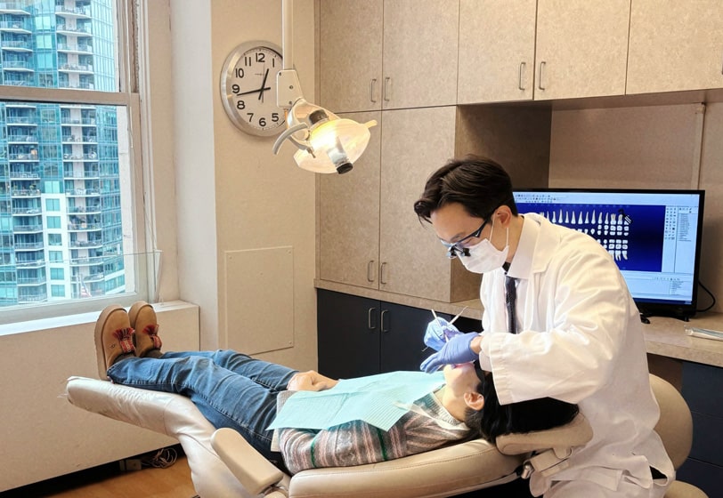 Dr. Shin providing dental care for his patient at Seattle dental office Moritis & Shin Dentistry